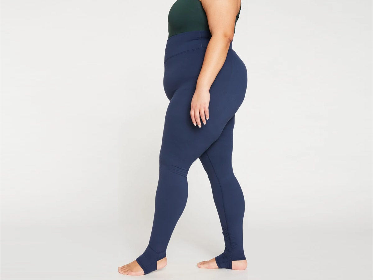 Woman wearing navy Universal Standard Stirrup Leggings.