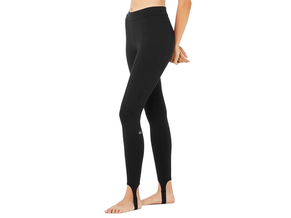 Woman wearing black Alo stirrup leggings.