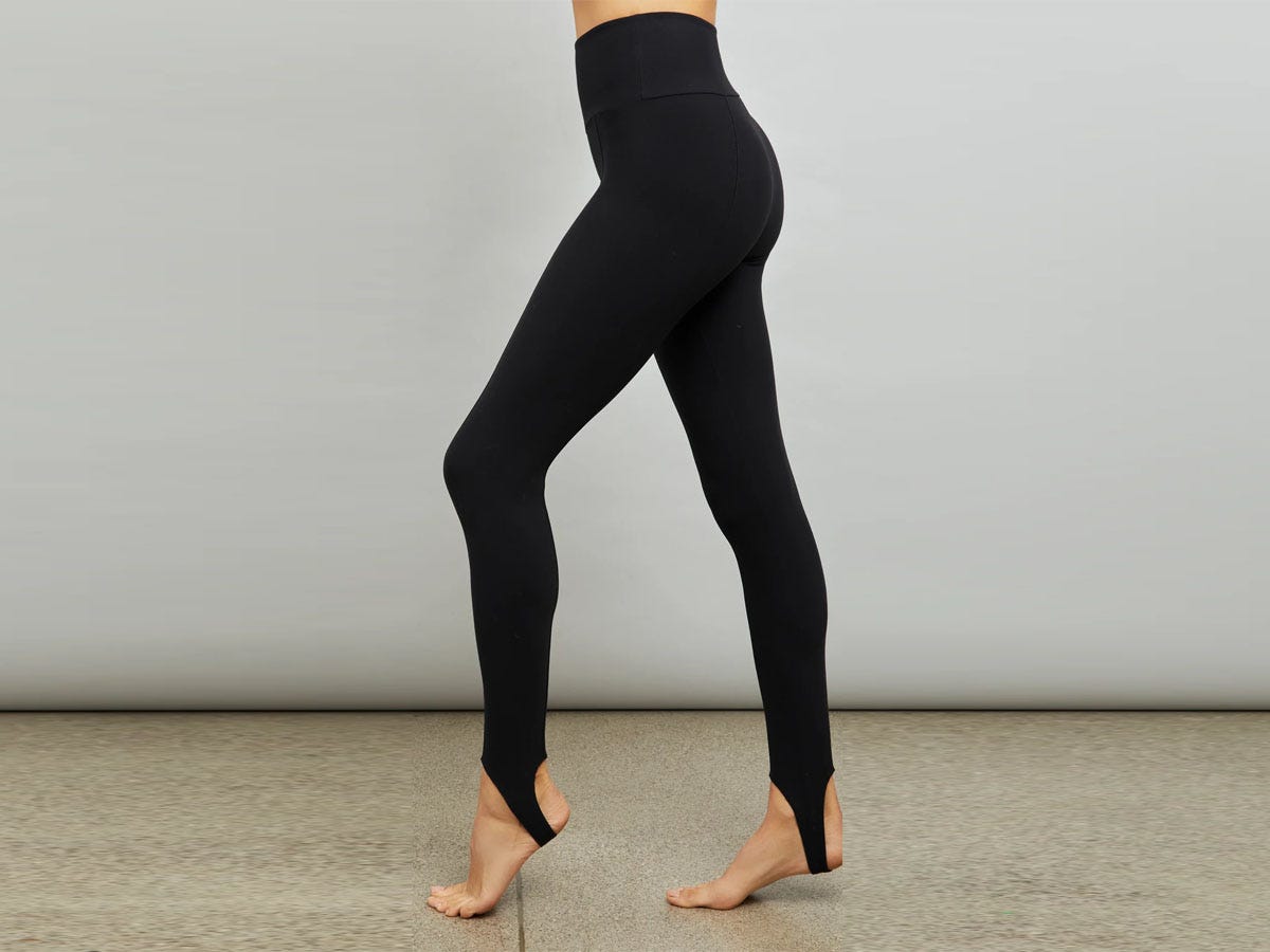 Woman wearing black Carbon 38 stirrup leggings.