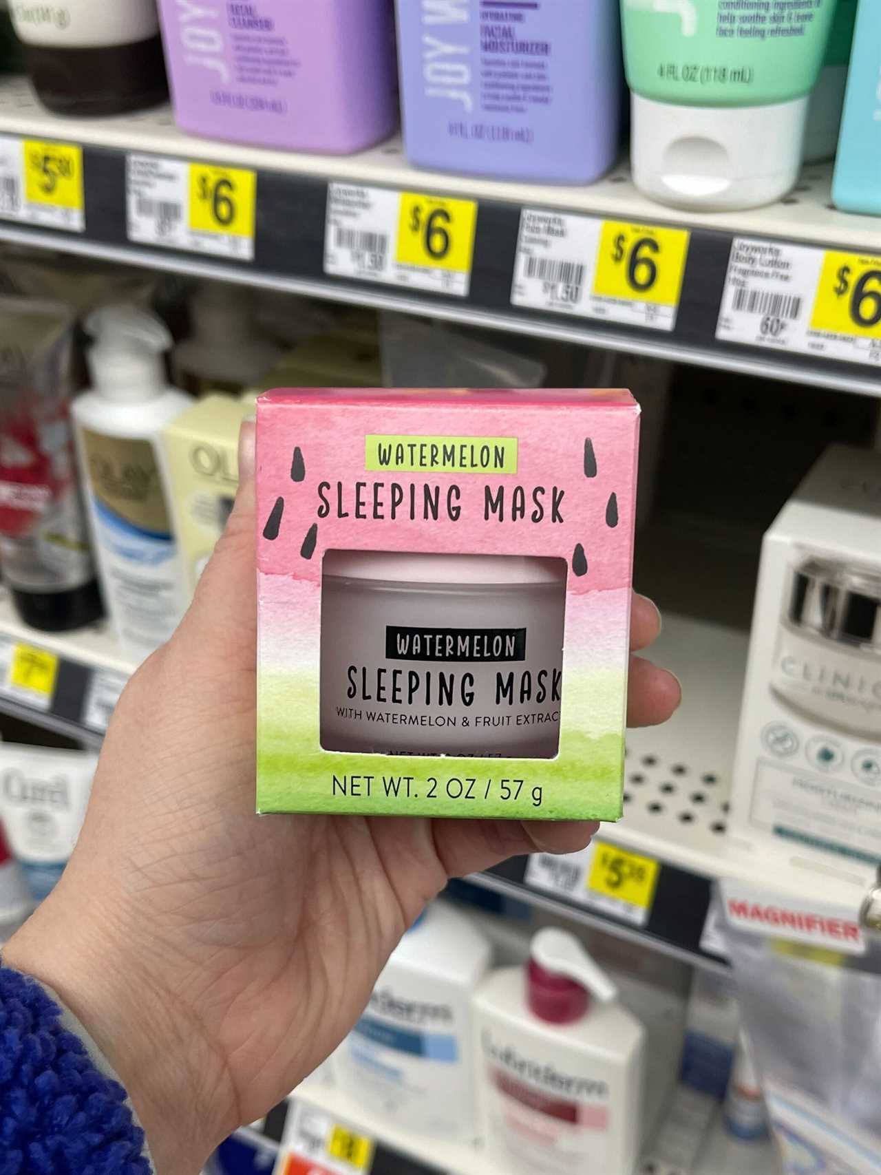 The photographer holds a two-ounce jar of Watermelon Sleeping Mask, packaged in a small box, in the beauty aisle of a Dollar General store in Ohio.