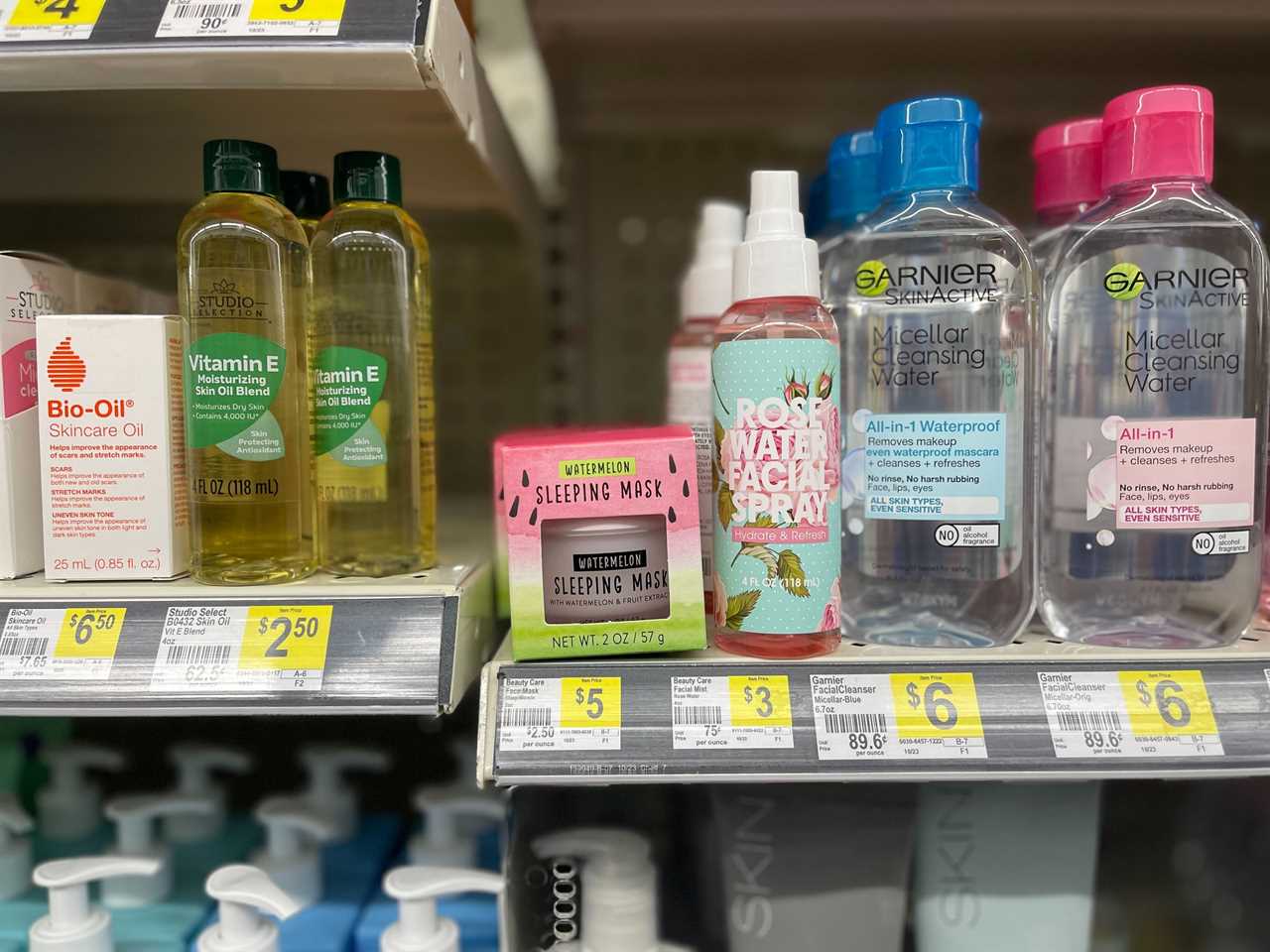 Beauty products, including Garnier Micellar Cleansing Water and unbranded rose water facial spray and watermelon sleeping masks, appear on a shelf at a Dollar General store in Ohio.