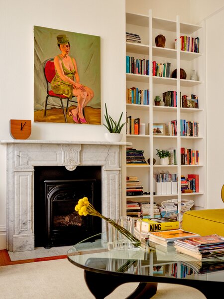 Aamer’s paintings hang throughout the apartment, including over the refurbished marble fireplace. Haddock considered Keith and Aamer’s book collection and designed sleek floor-to-ceiling shelving. 