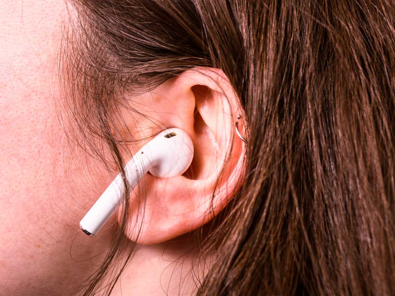 A person using Apple Airpods.