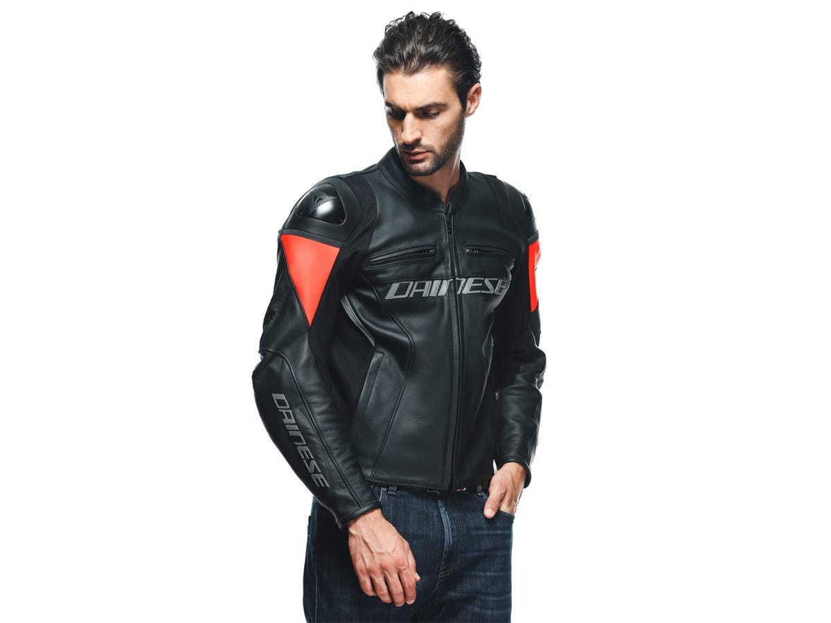 A model wearing a black and fluo-red Dainese Racing 4 Leather Jacket.