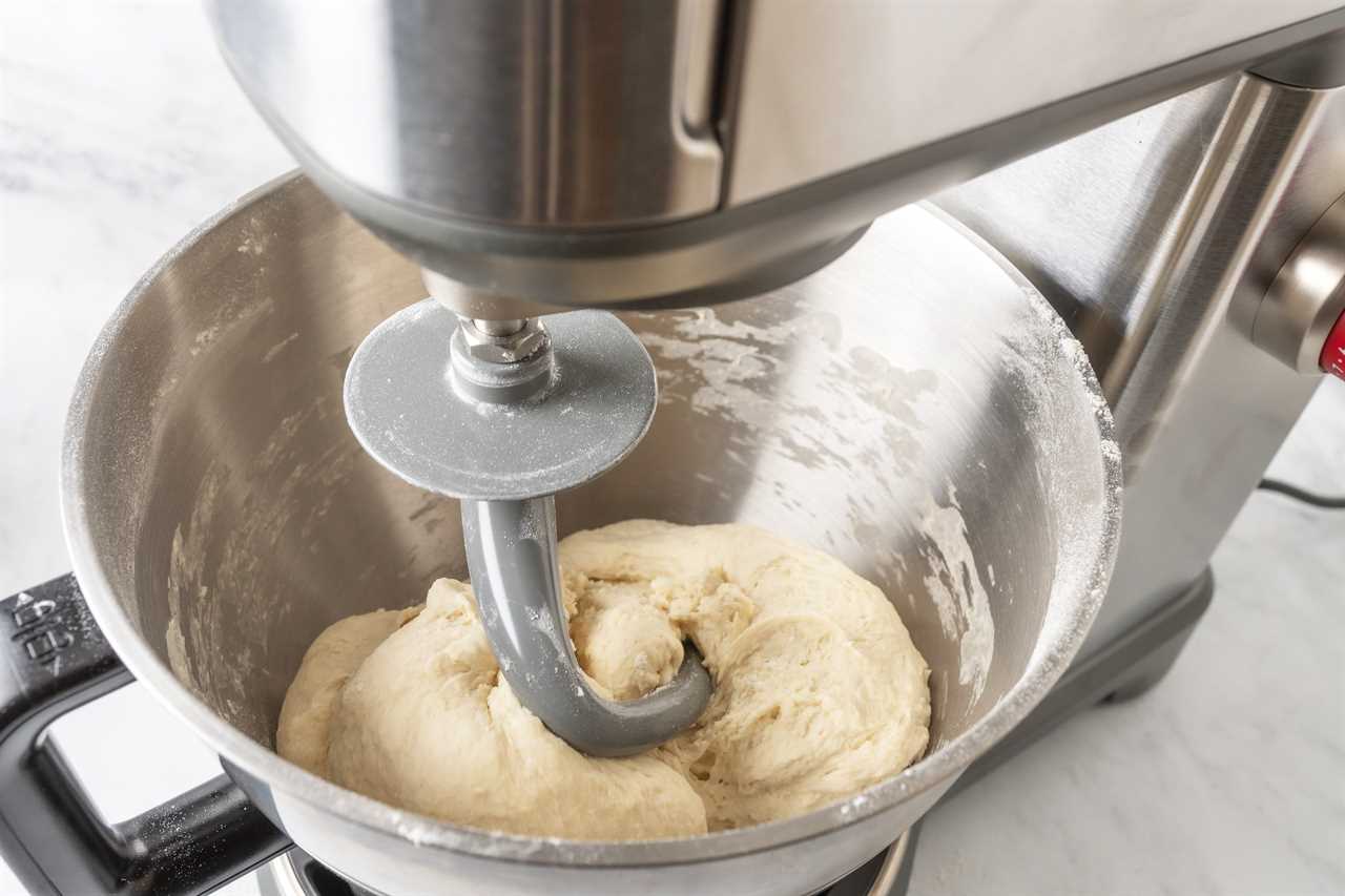 A close-up shot of bread dough being kneaded by the dough hook in the Wolf Gourmet Stand Mixer.