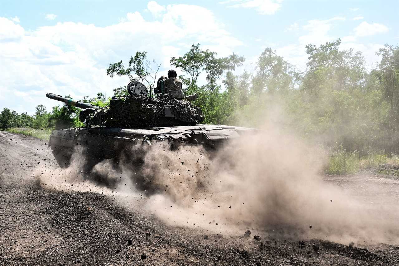 Ukrainian servicemen drive a T-72 tank on the frontline in eastern Ukraine on July 13, 2022, amid the Russian invasion of Ukraine.