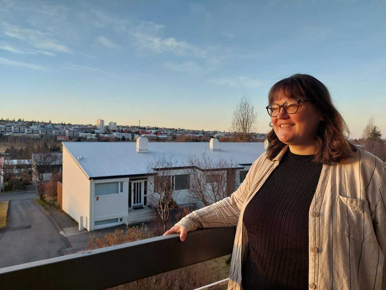 Sonia Nicolson stood on the balcony of her apartment in Reykjavik. There are houses and sky in the background