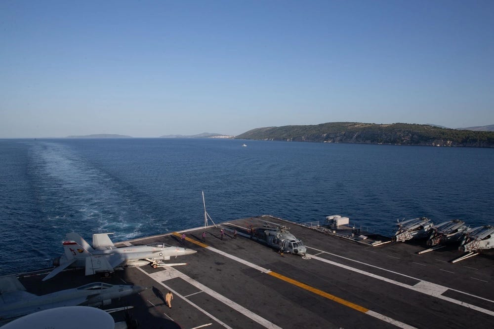 an aircraft carrier sails off the coast of croatia