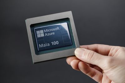 A person holding Microsoft’s Azure Maia 100 AI chip