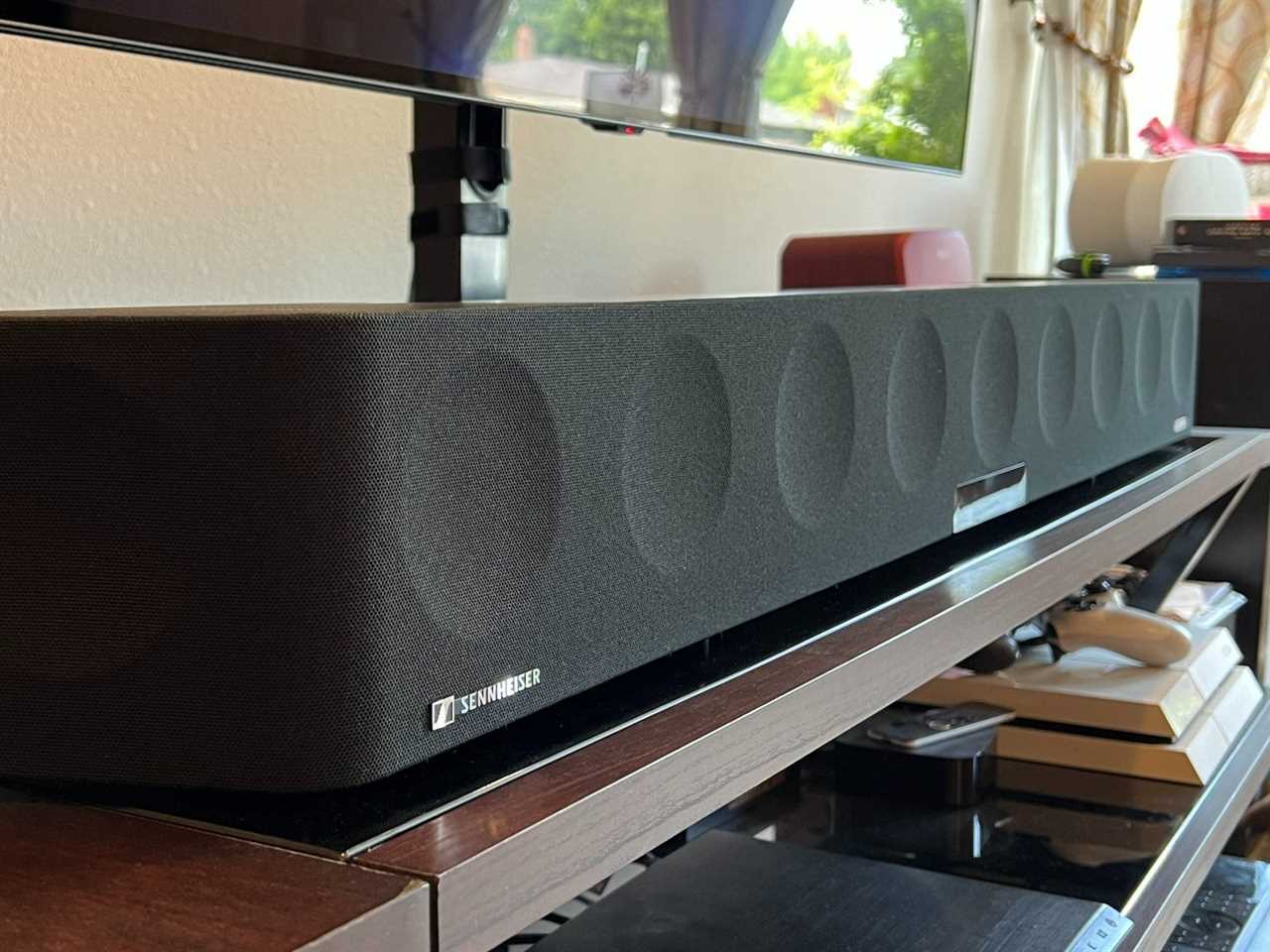 A Sennheiser Ambeo Max soundbar resting on an entertainment console.