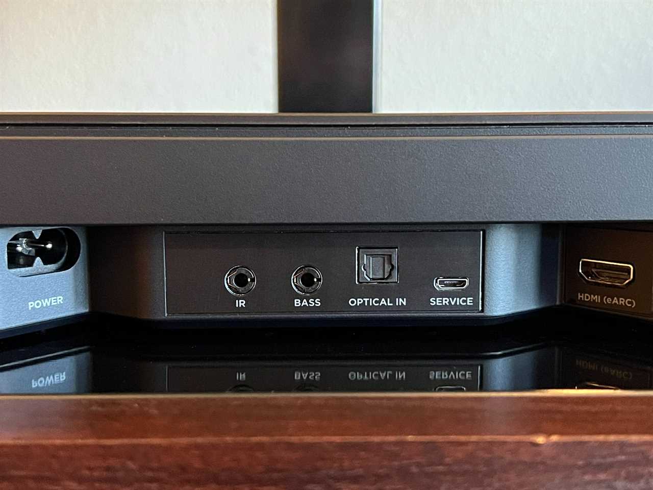 The Bose Smart Soundbar 600 inputs shown on a wooden console.