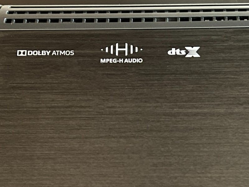 A close-up of the format logos features on the Sennheiser Ambeo Max soundbar.