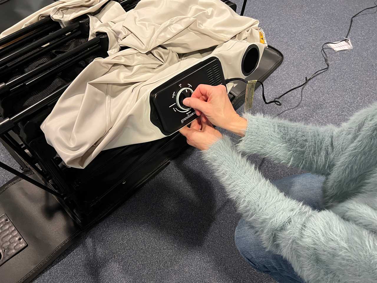 A woman handles the dial on the EZ Bed mattress