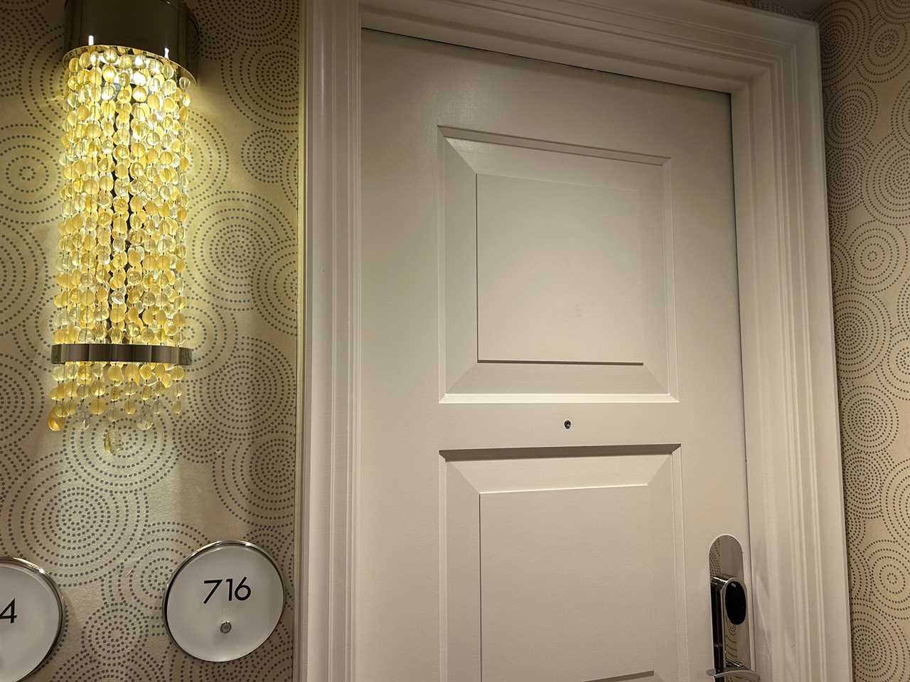 Disney World Four Seasons white door with door bell next to it 