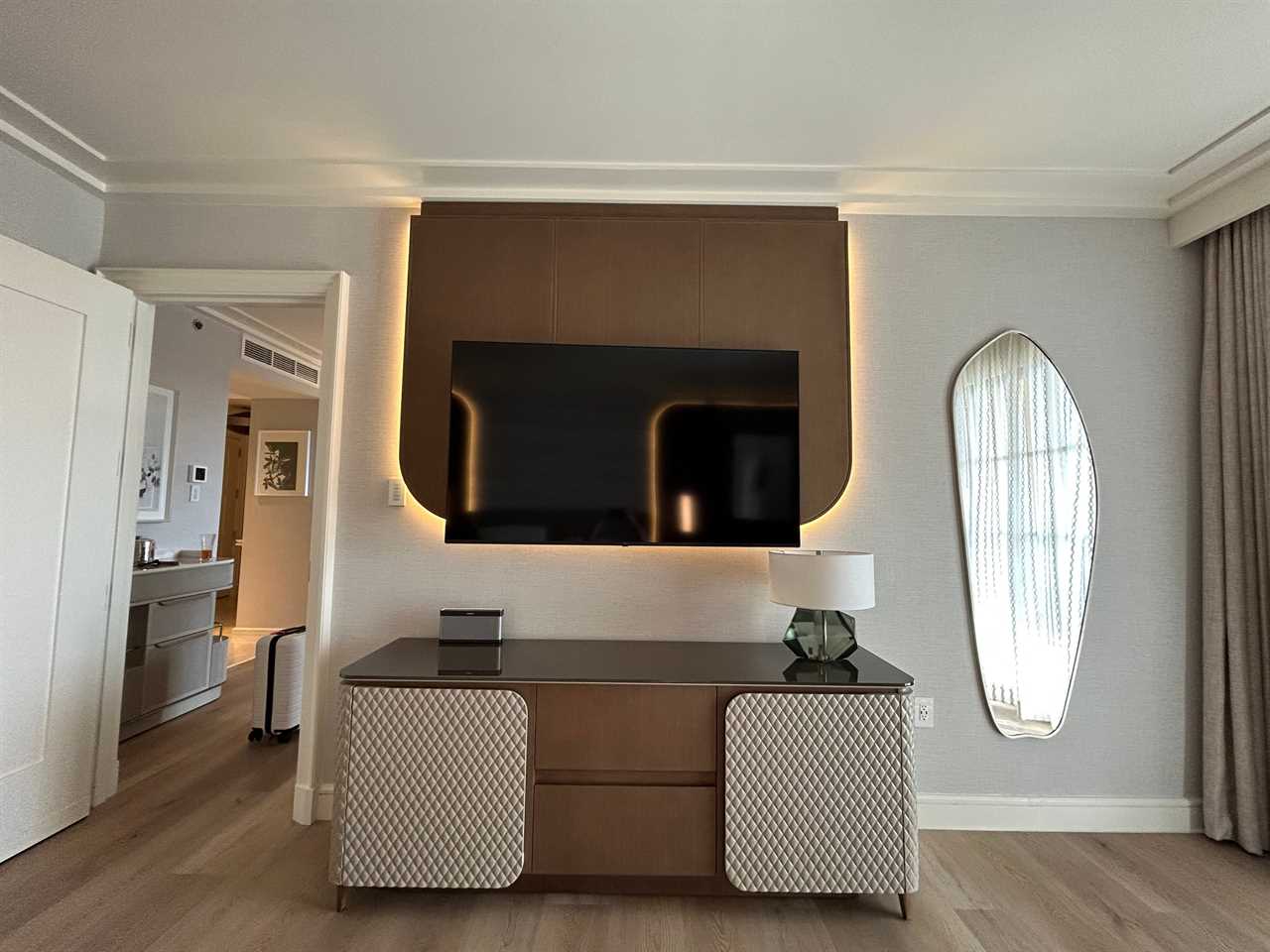 Backlit mirror with dresser underneath in Disney World Four Seasons suite