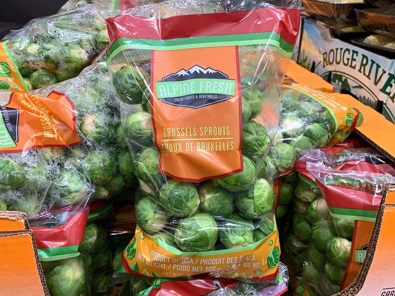 Bags of Alpine Fresh Brussels sprouts on display at Costco.