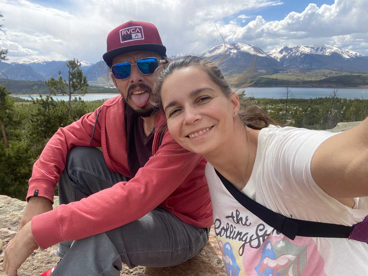 a couple takes a selfie on a mountain