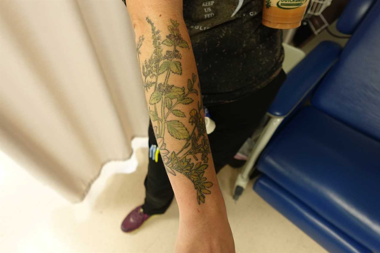 Photograph of a nurses arm showing her tattoos.