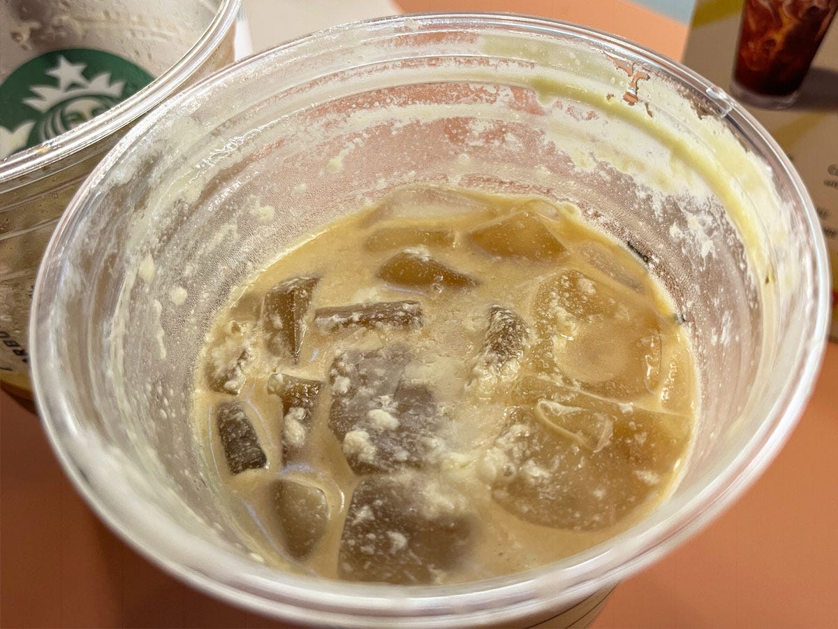 close up of oleato starbucks drink, olive oil accumulating on top