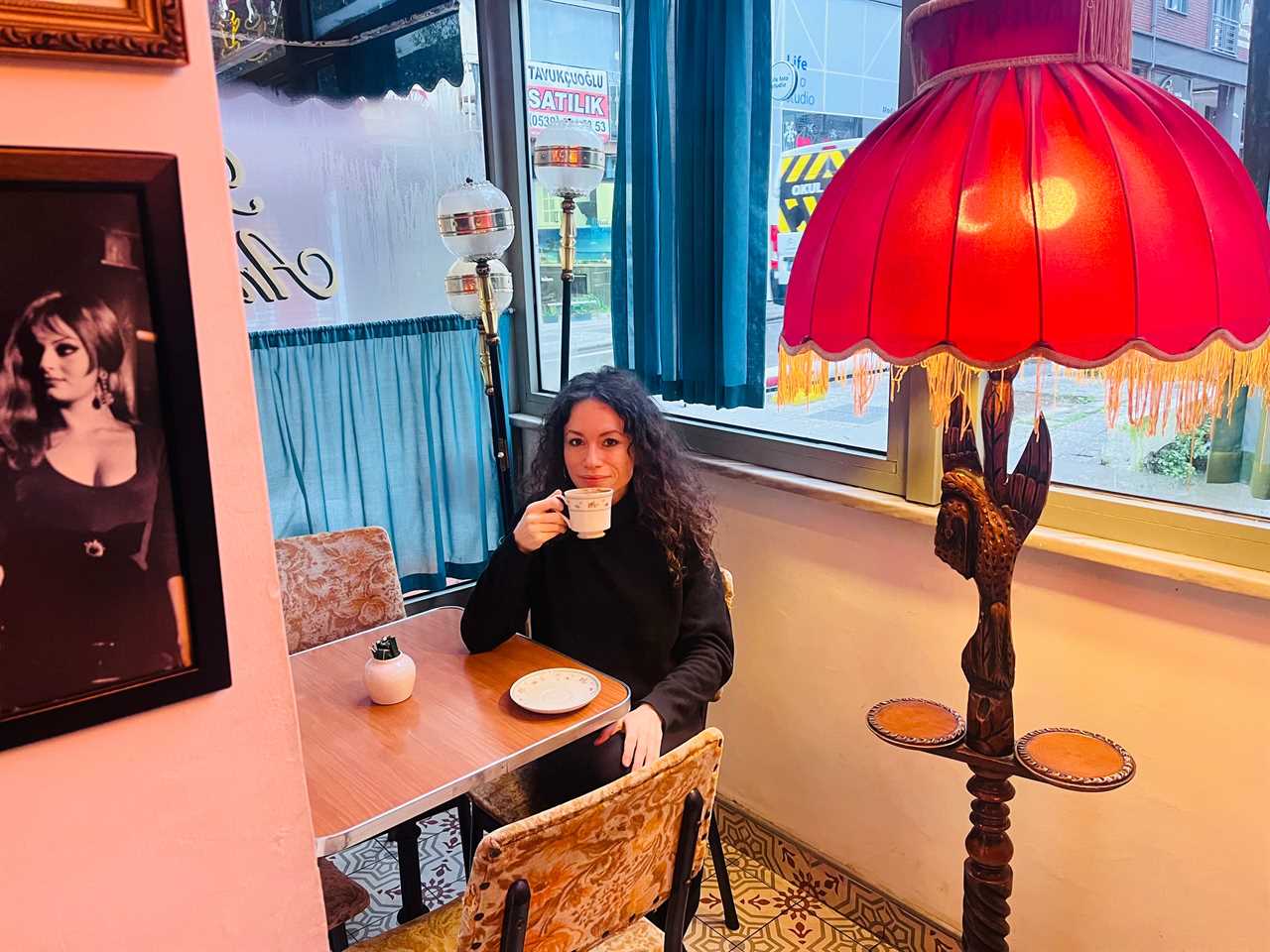 Author Maria Mocerino drinking coffee in a coffee shop in Istanbul