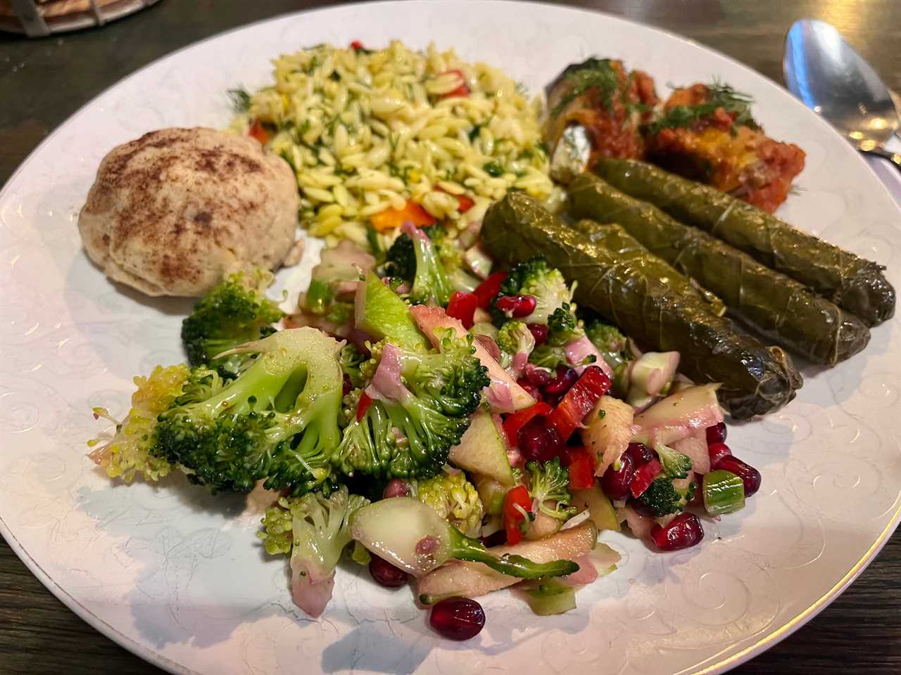 Plate of vegetables, grape leaves, and other foods