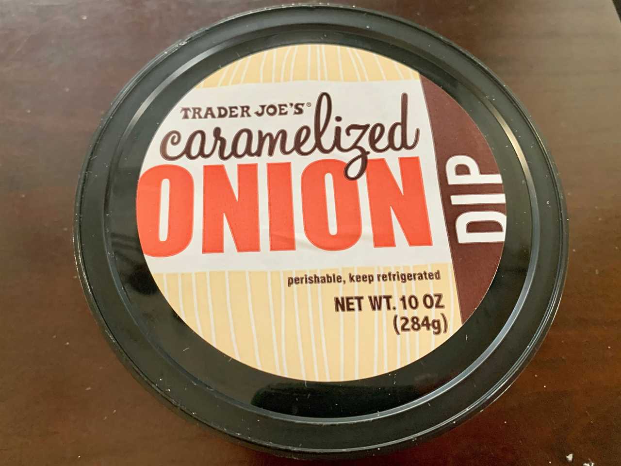 trader joe's caramelized onion dip in brown and black package on wood table