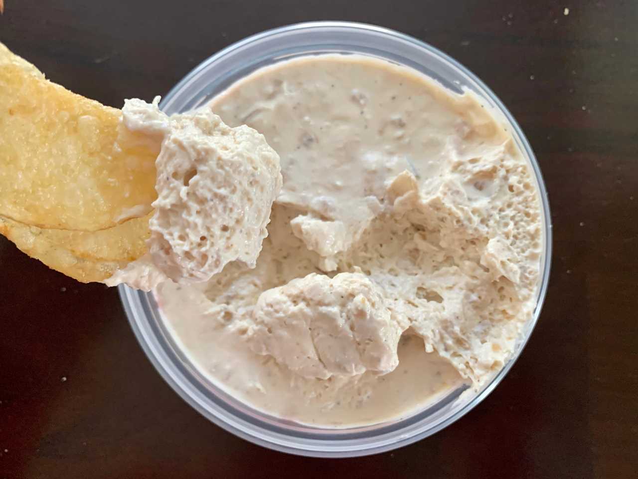 chip dipping into trader joe's caramelized onion dip