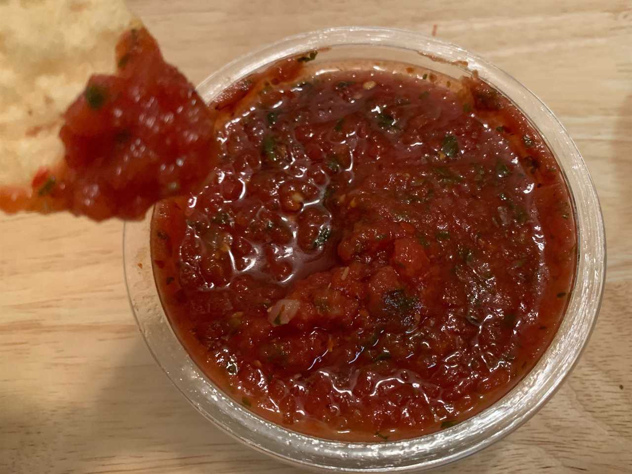 chip dipping into trader joe's salsa especial