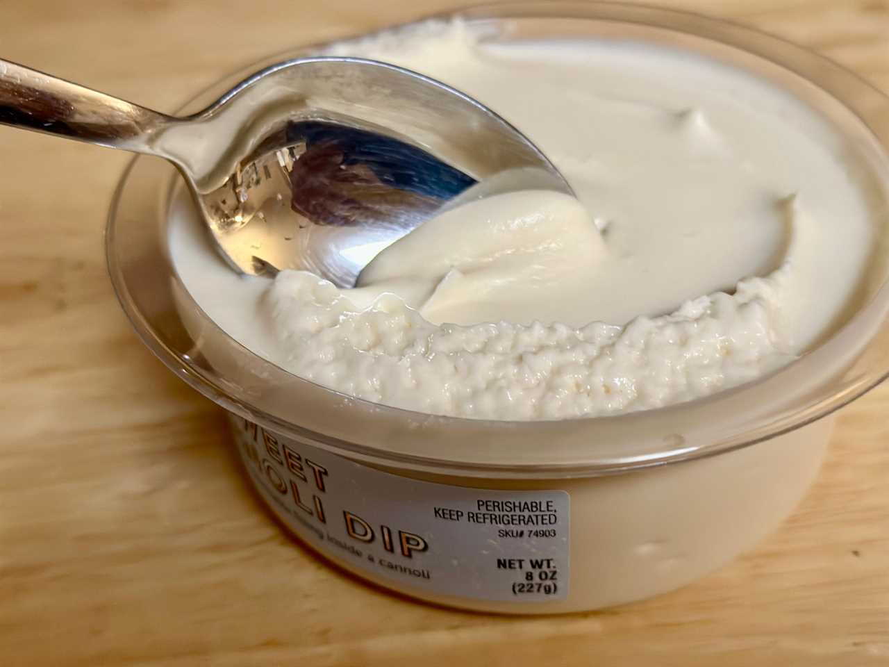 A spoon scoops through Trader Joe's sweet cannoli dip