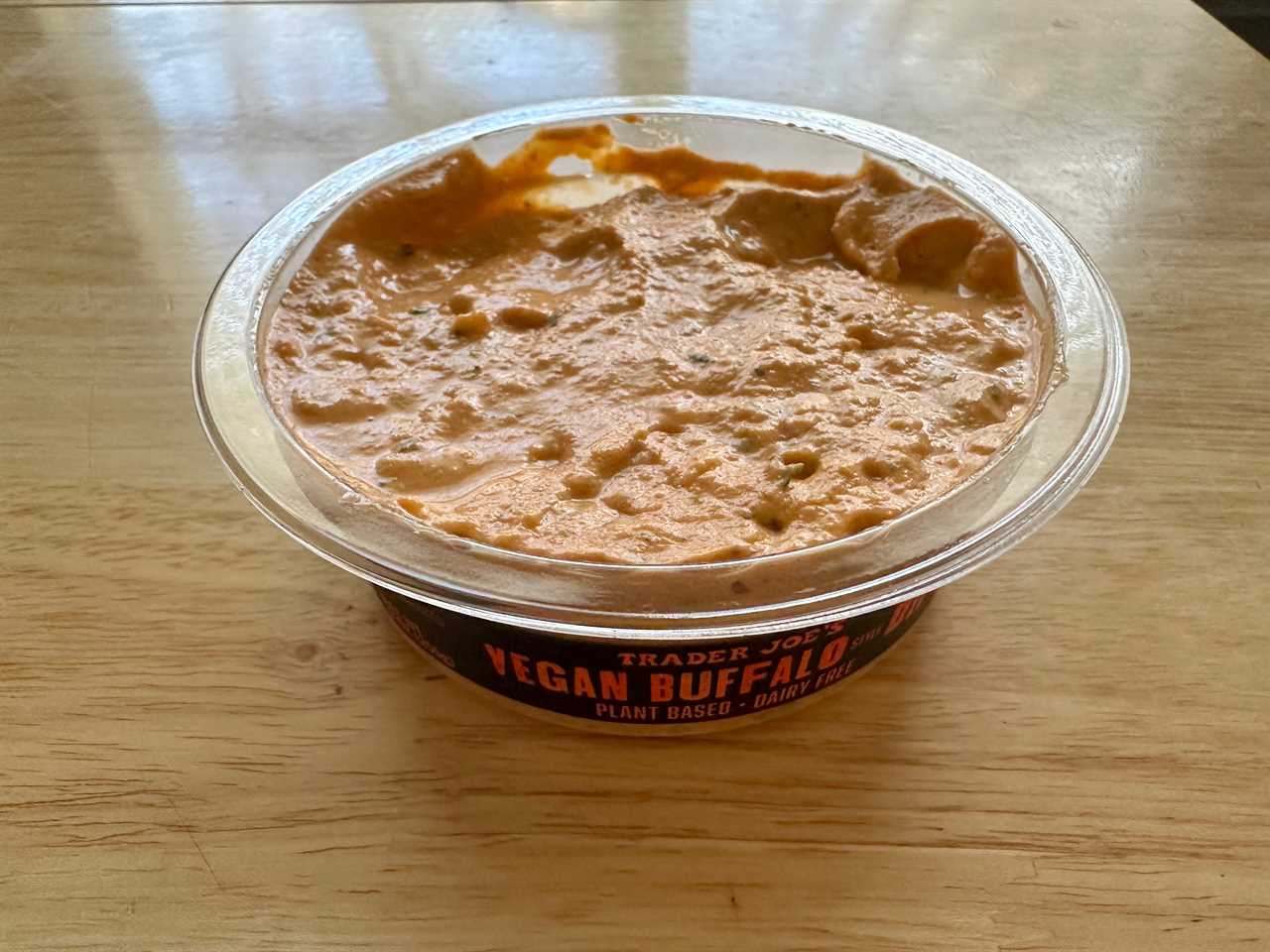 An open container of Trader Joe's vegan Buffalo dip on a table