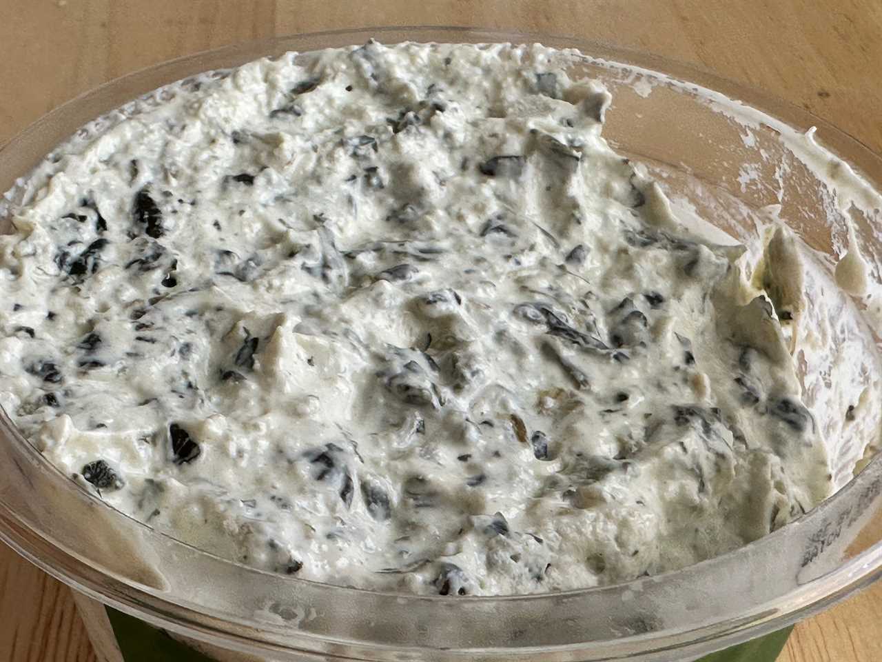 Close up of an open container of Trader Joe's sour-cream spinach dip