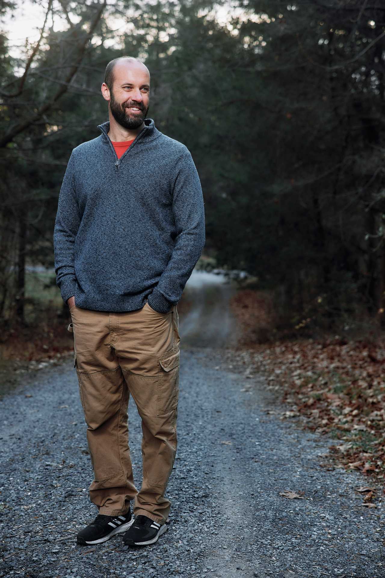 Man standing in a dirt road.