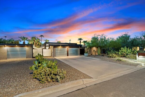 The home's entry courtyard is tucked behind frosted glass, enhancing the sense of privacy.