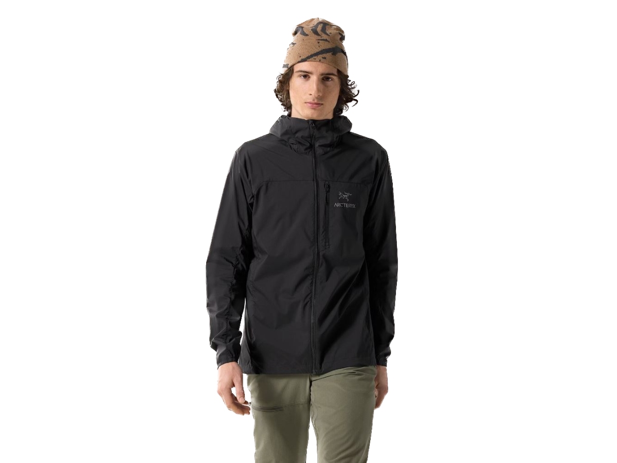 A man wearing a black Arc'teryx rain jacket