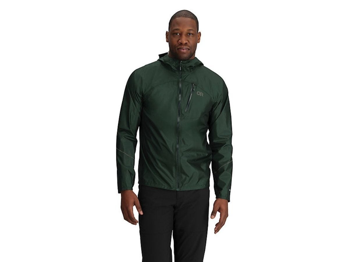 A man wearing a dark green rain jacket from Outdoor Research