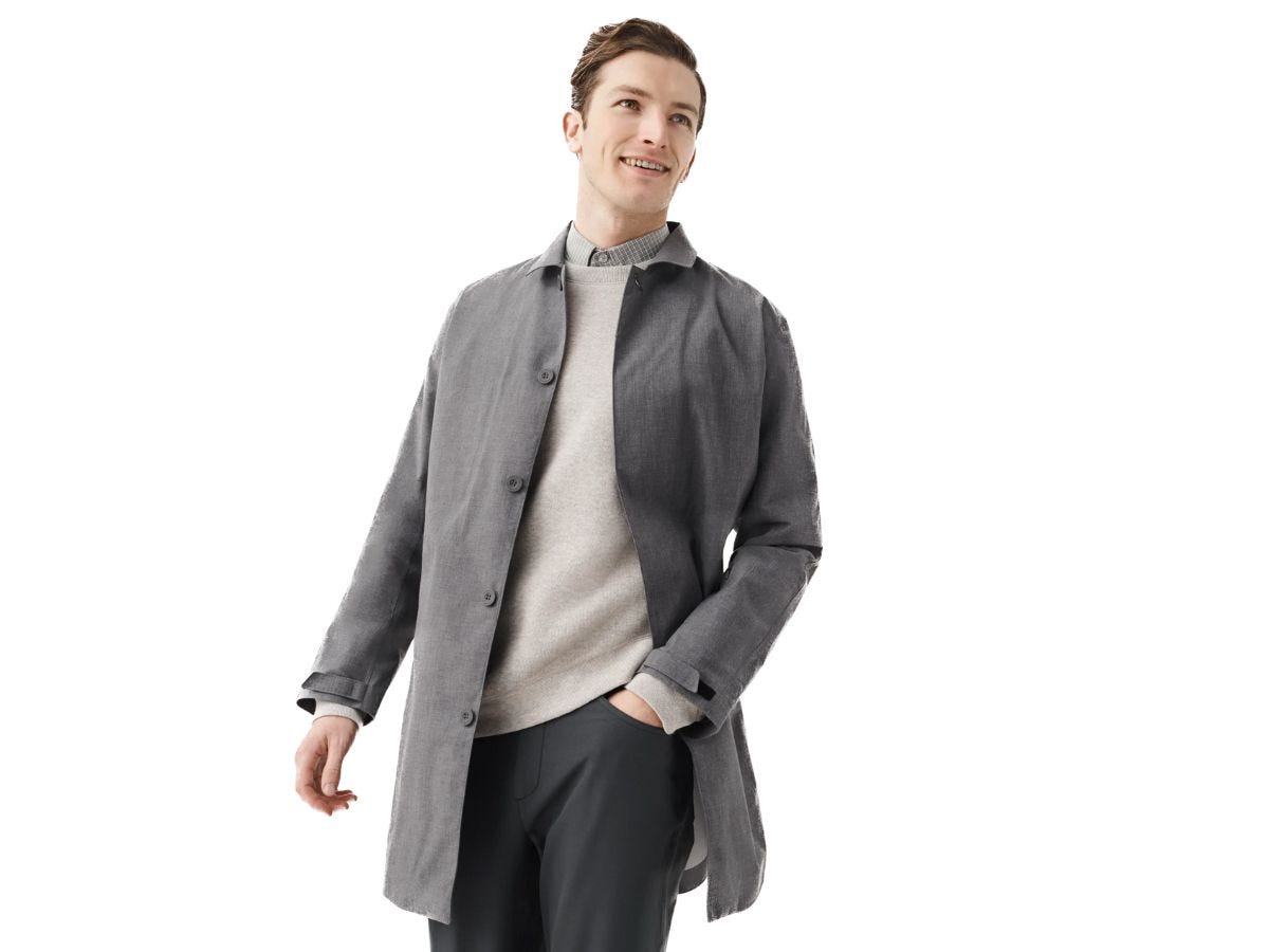 A man wearing a grey rain jacket from Mack Weldon