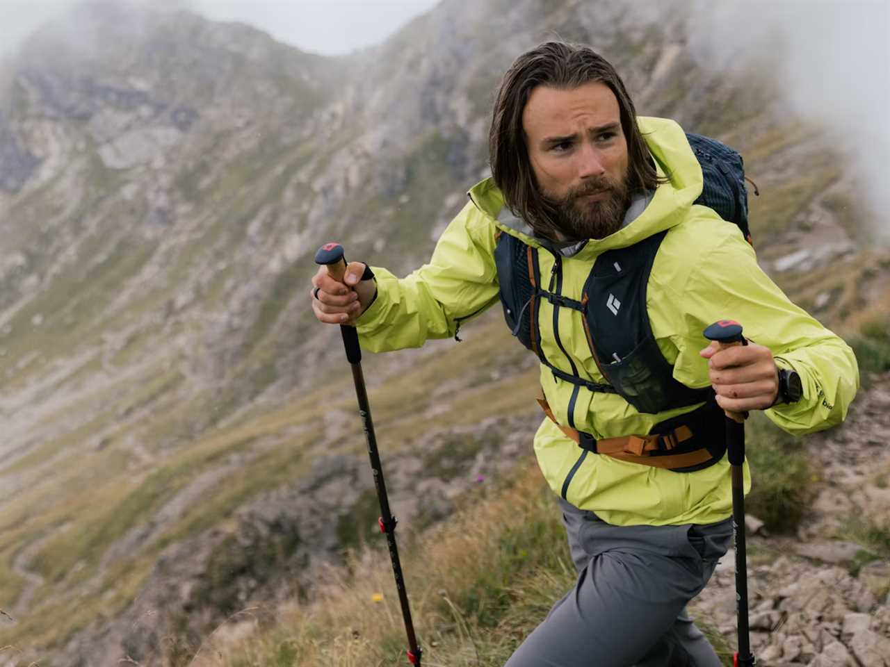 A man wearing a rain jacket while hiking