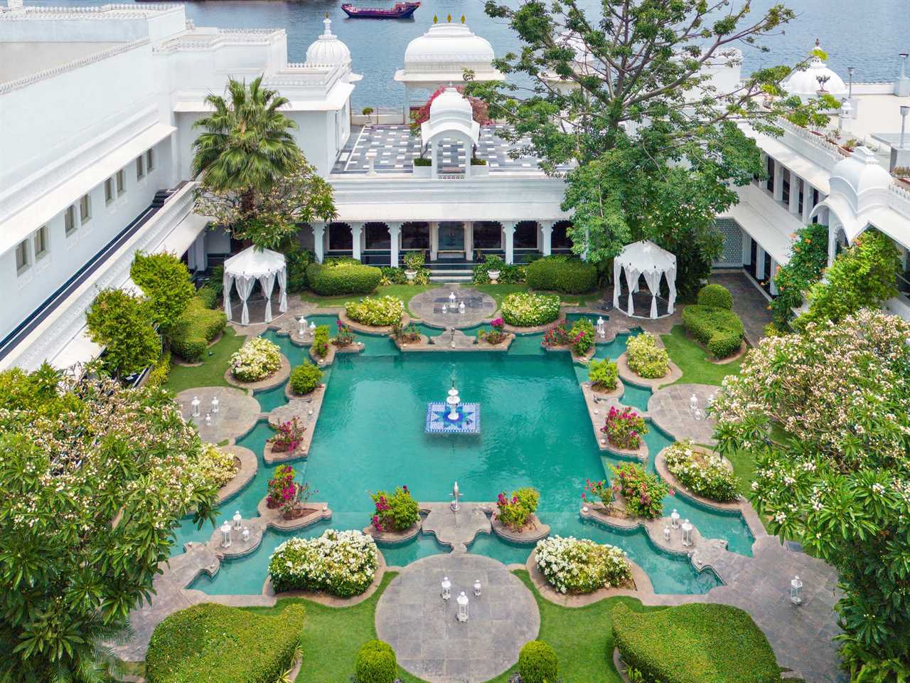 A beautiful hotel courtyard with a man-made pond and a garden.