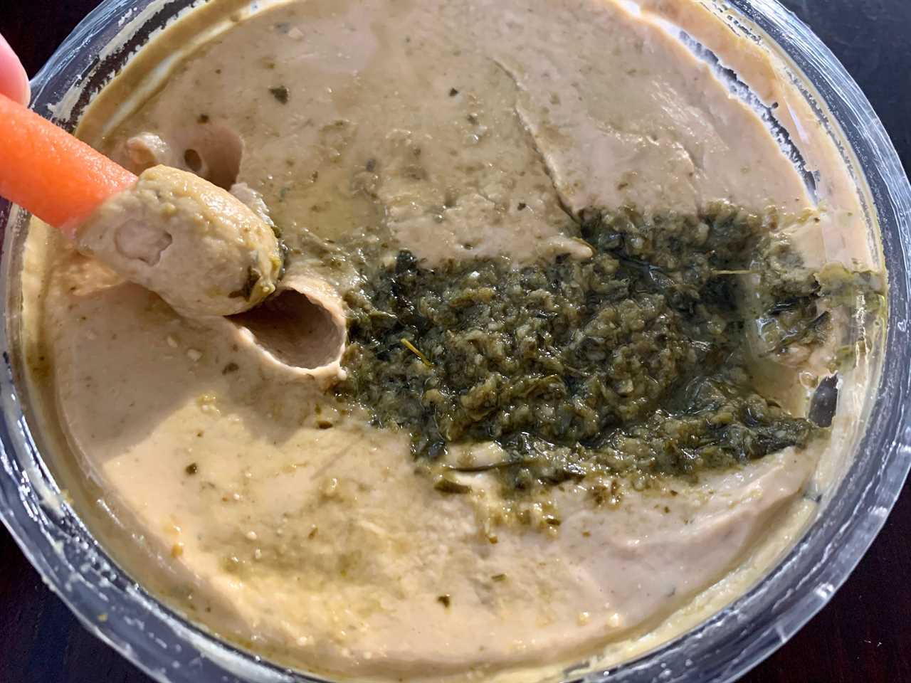 carrot dipping in trader joe's cilantro jalepeno hummus