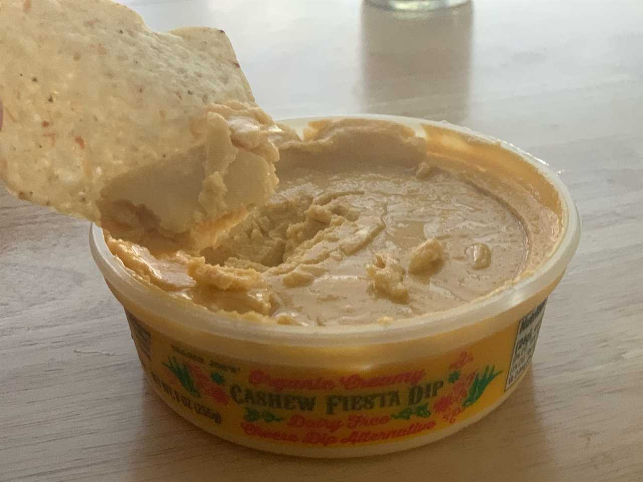 chip dipping into trader joe's cashew fiesta dip