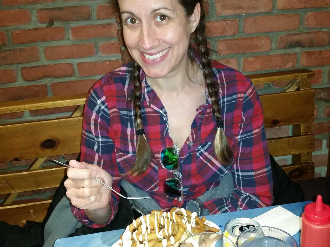 a woman eating poutine