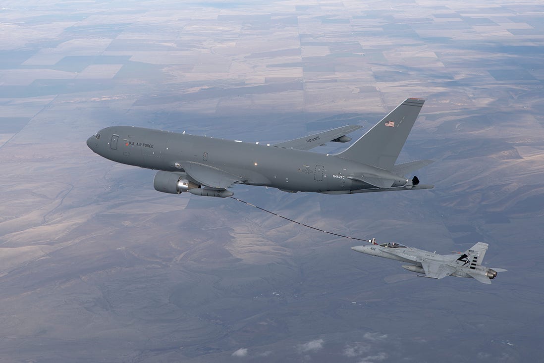 A KC-46 refueling via hose-and-drogue midair.