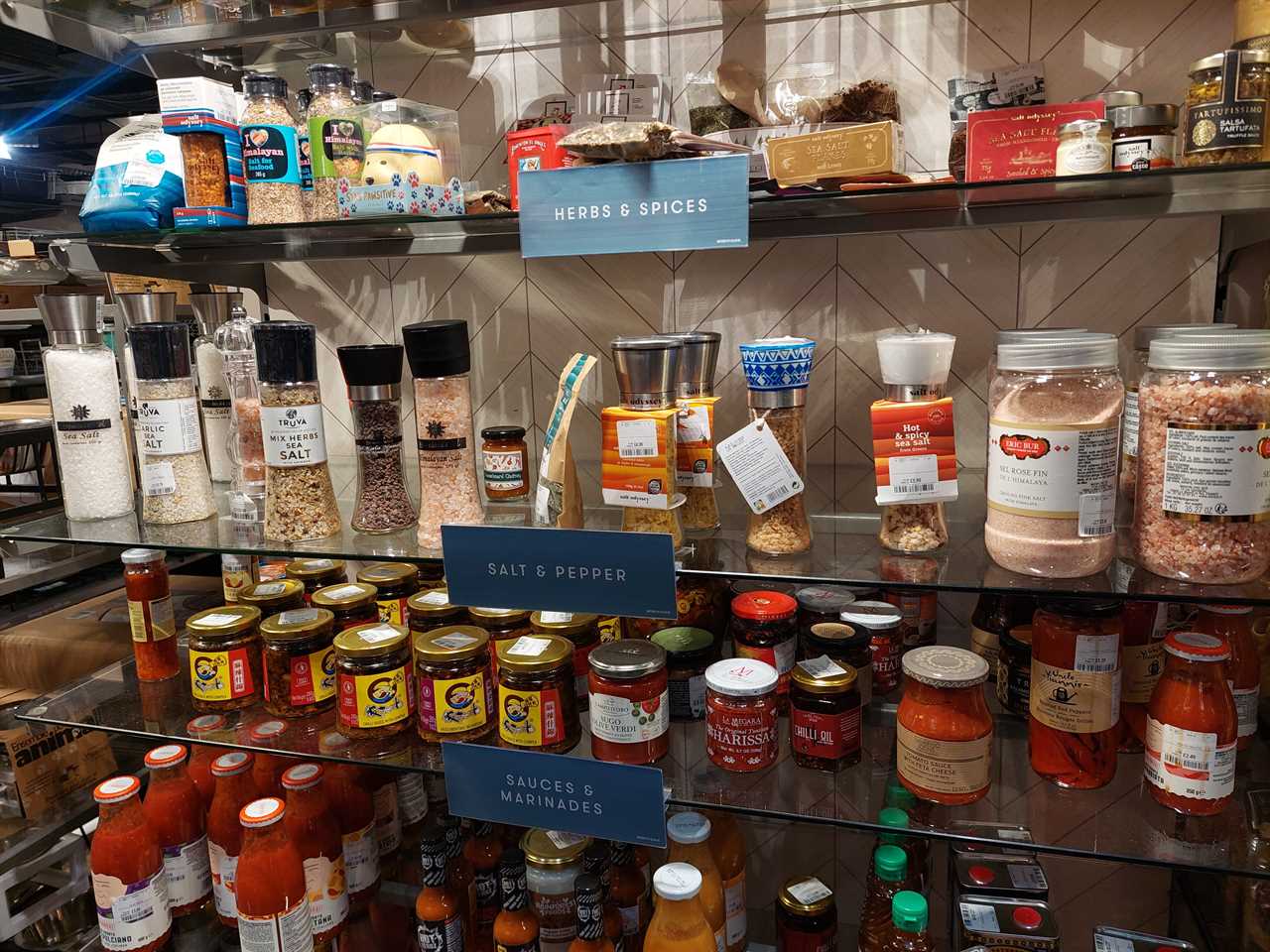 The food aisle in a T.K. Maxx store in London showing shelves of salt and sauces.