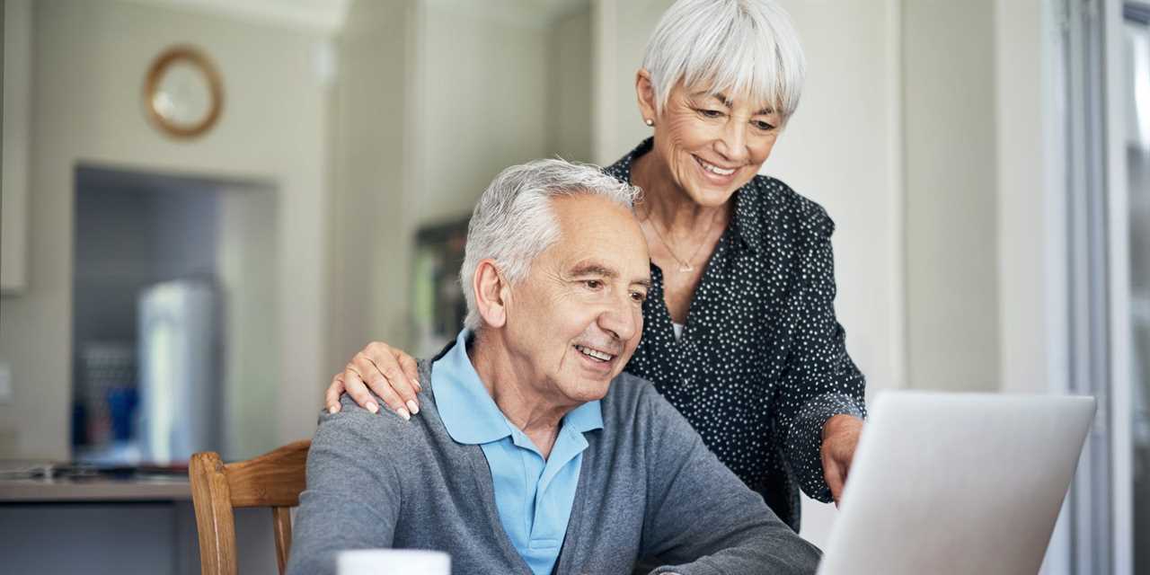 Older couple looking at a computer and smiling