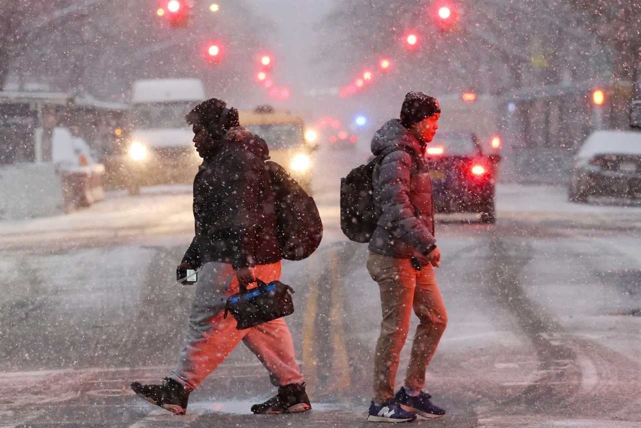 People walk as the snow falls during a Nor'easter winter storm in New York City, U.S., February 13, 2024.