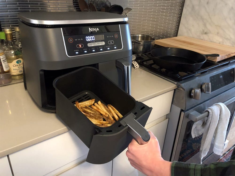 Ninja Foodi Two-Basket Air Fryer cooking french fries.