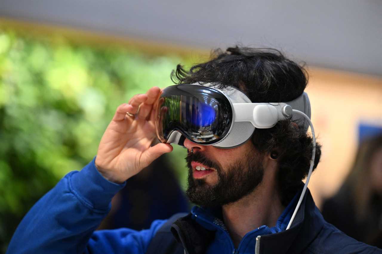 A customer tries on the Apple Vision Pro headset during the product launch at the Apple Store in New York City on February 2, 2024.