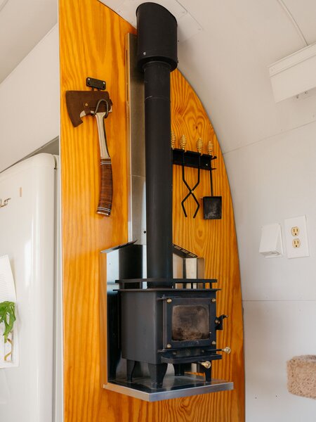 A woodburning stove from Cubic provides ambience and supplements heat from a furnace. 