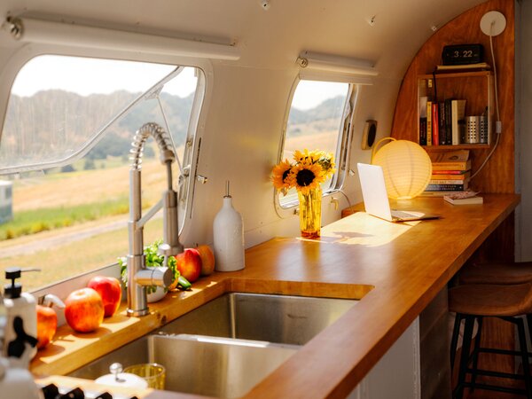 A long maple butcher block forming a kitchen counter and work surface replaced one of the trailer’s two twin beds.