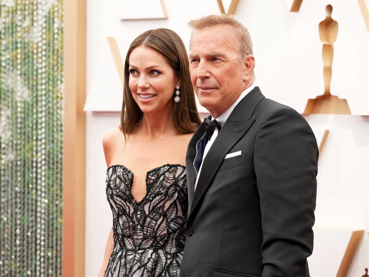 Christine Baumgartner and Kevin Costner attend the 94th Annual Academy Awards at Hollywood and Highland on March 27, 2022 in Hollywood, California.